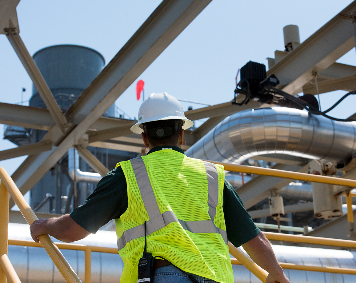 Man walks up stairs at gas plant